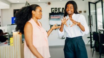 Two women engaging in a vibrant discussion at Café One in Lagos, Nigeria.
