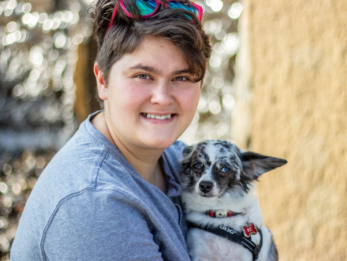 a woman holding a small dog in her arms