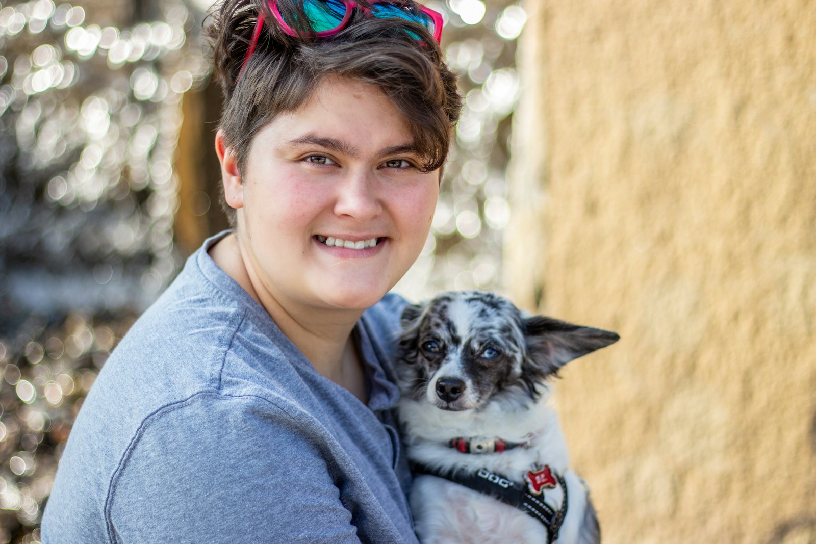 a woman holding a small dog in her arms