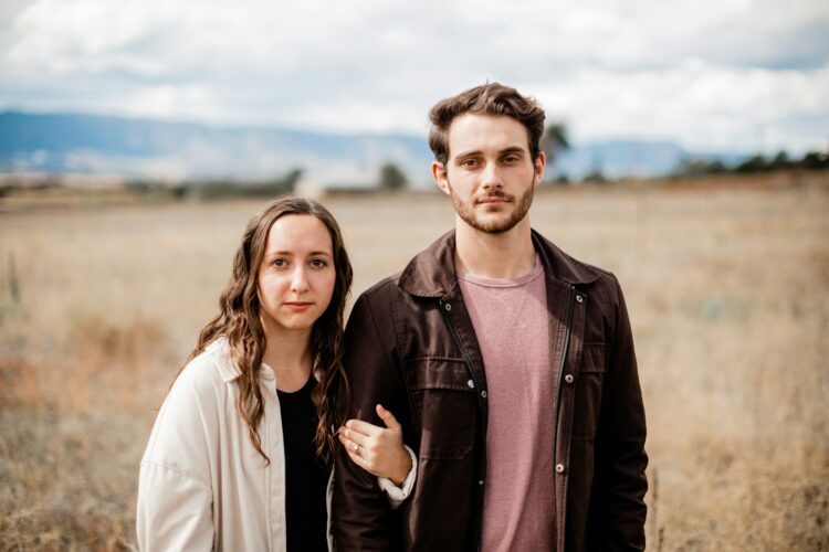 A man and a woman standing in a field