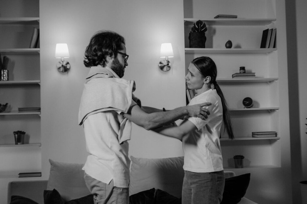Black and white photo of a couple in a serious discussion indoors.