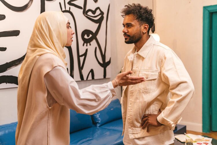 A man and woman in an intense conversation at home, evoking emotions.