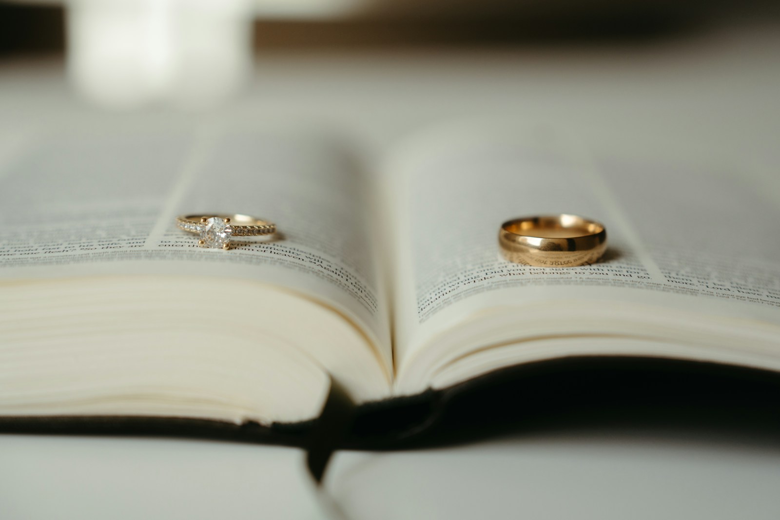 A close up of two wedding rings on an open book