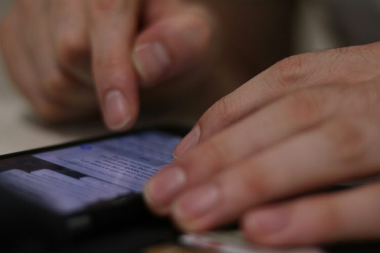 a close up of a person using a cell phone