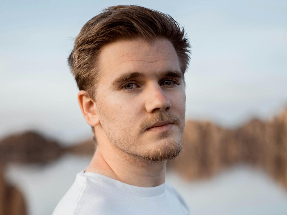 a man standing in front of a body of water