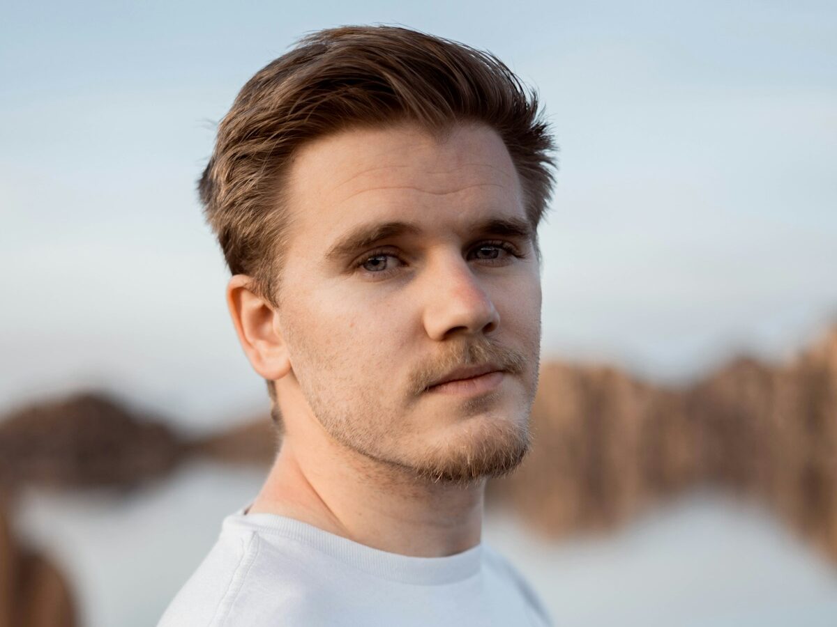 a man standing in front of a body of water