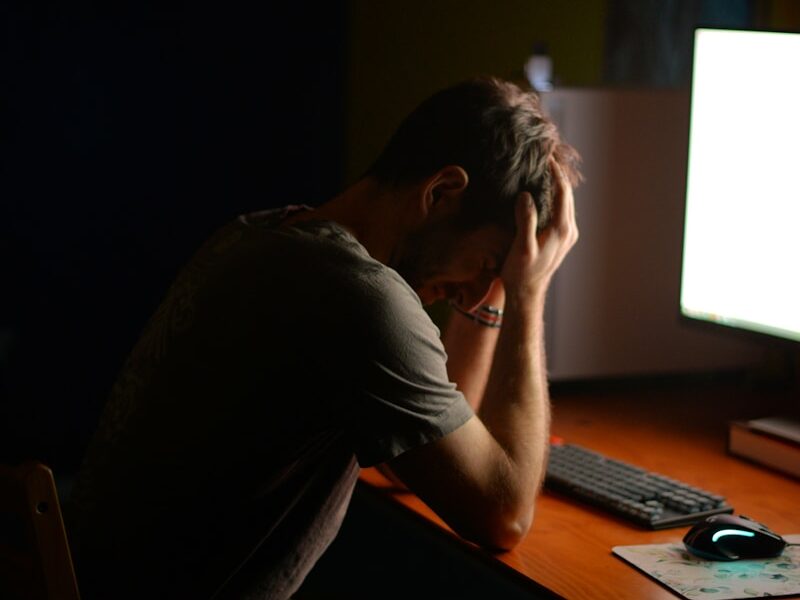 a man sitting at a desk in front of a computer