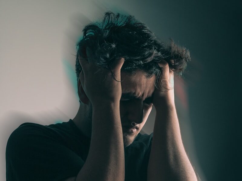 a man holding his head in his hands