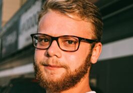 man in white crew neck shirt wearing black framed eyeglasses