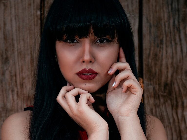 woman in red lipstick and black mascara