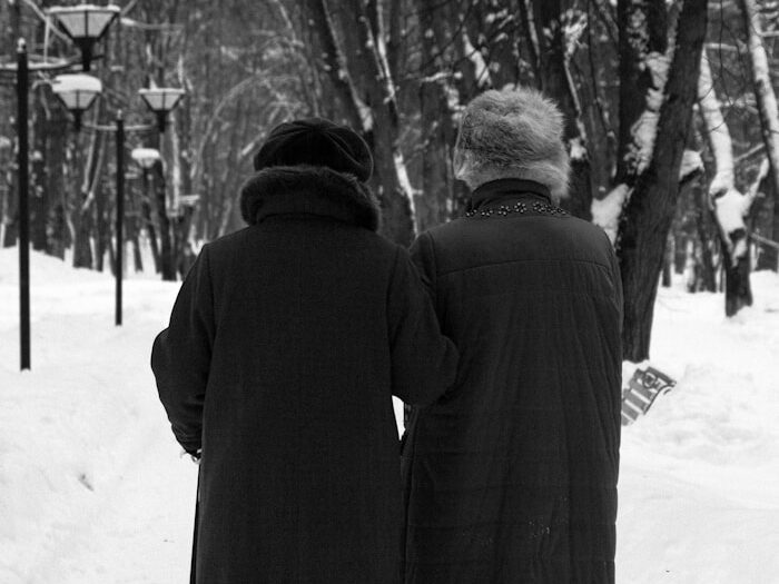 a couple of people that are walking in the snow