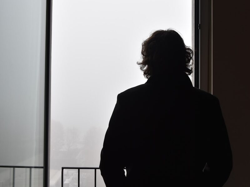 a man standing in front of a window