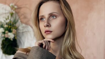 Beautiful woman poses thoughtfully in a blazer.