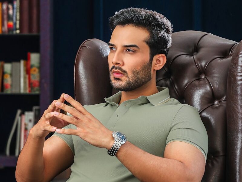 A man is deep in thought while sitting.