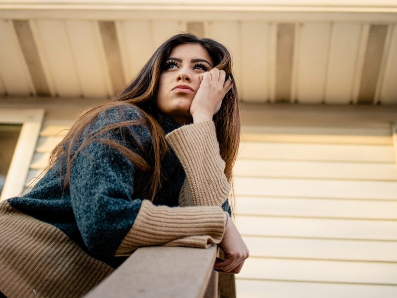 woman in blue denim jacket and brown scarf