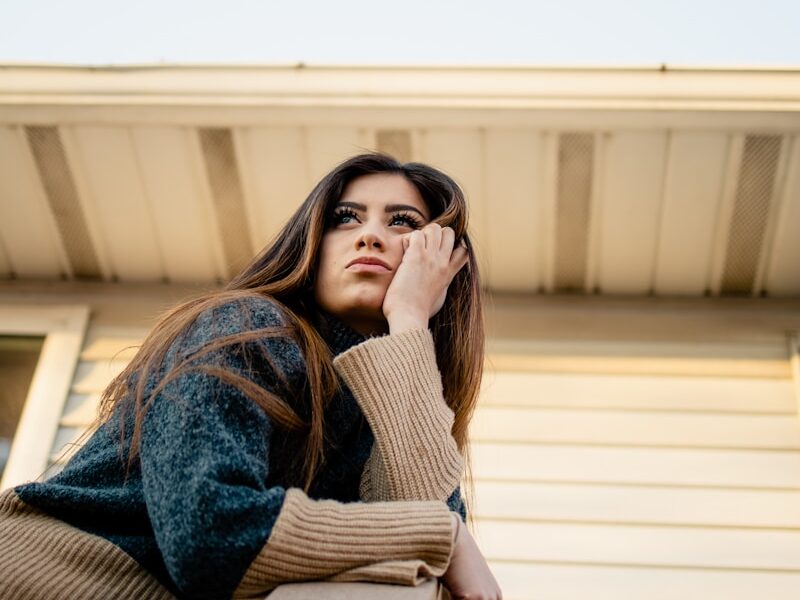 woman in blue denim jacket and brown scarf
