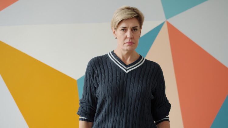 Woman with short blonde hair in a sweater