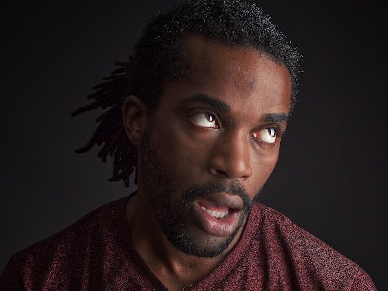 man opening his mouth and looking up