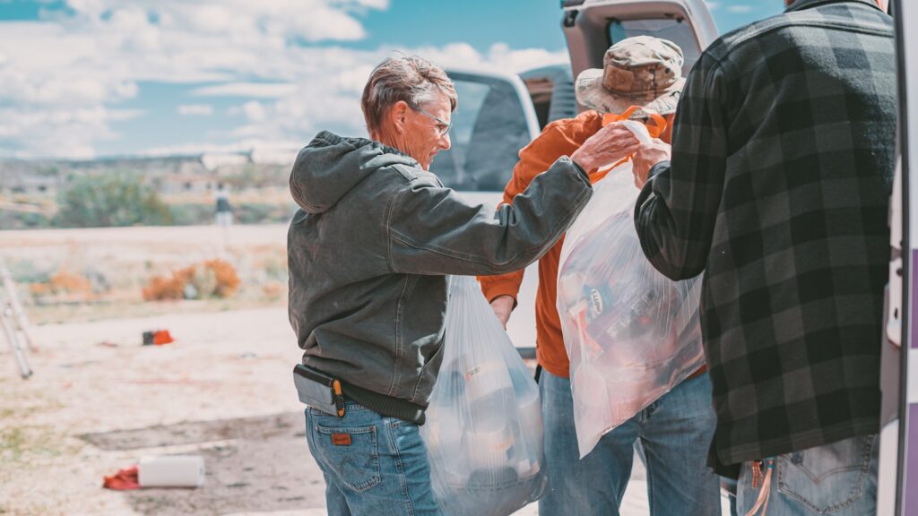 a group of people standing around a truck