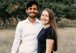 A man and a woman standing in a field