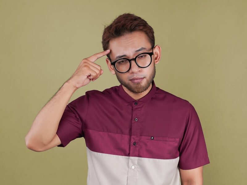 a man with glasses is posing for a picture