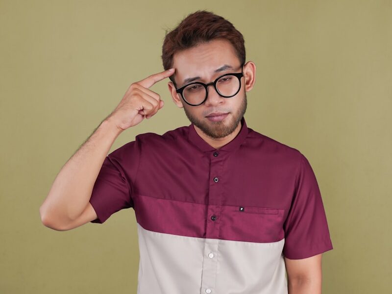 a man with glasses is posing for a picture