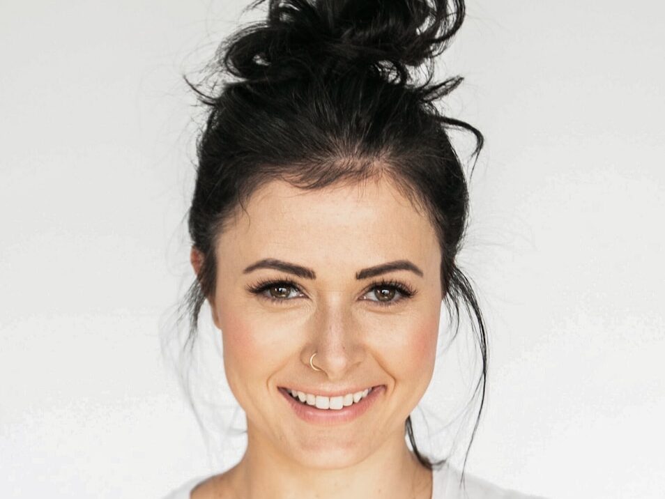 woman in white crew neck shirt smiling