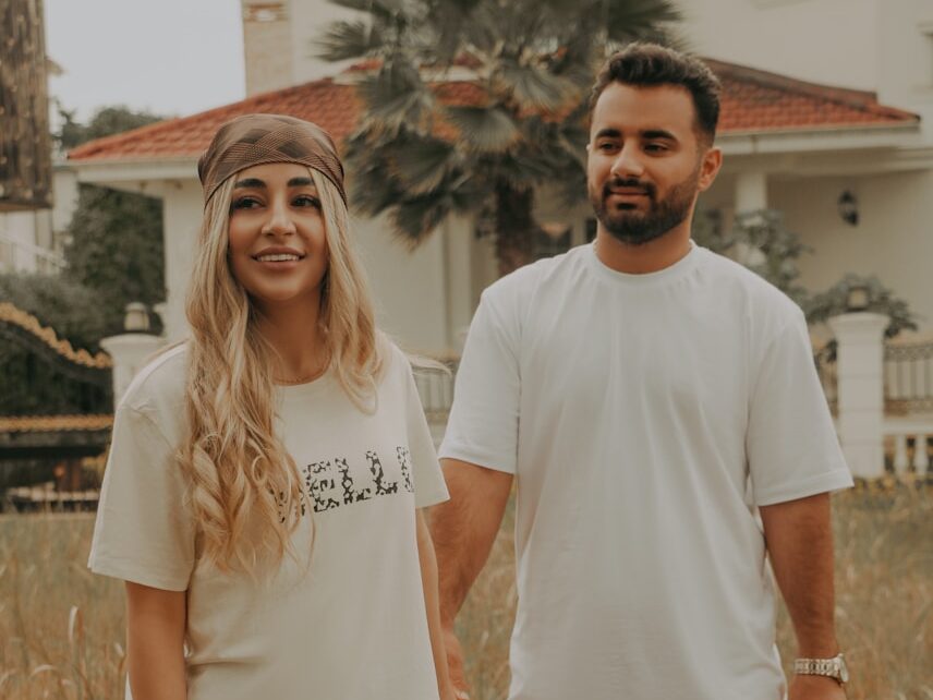 a man and a woman standing in a field