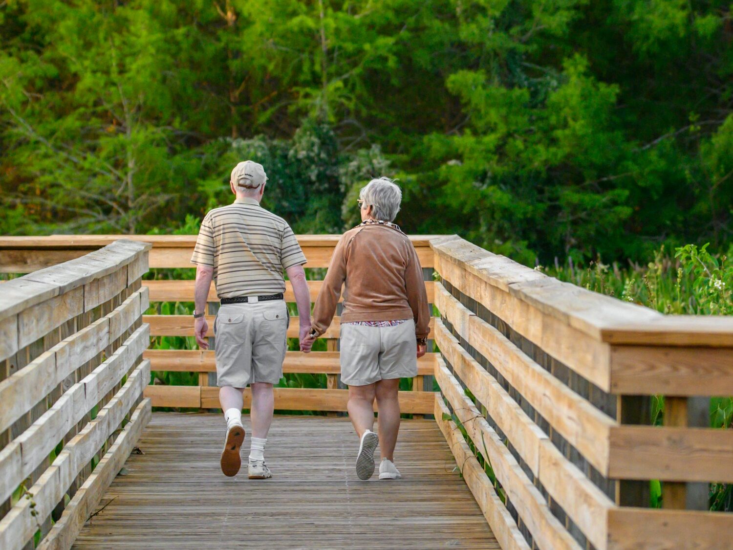 a couple of people that are walking across a bridge