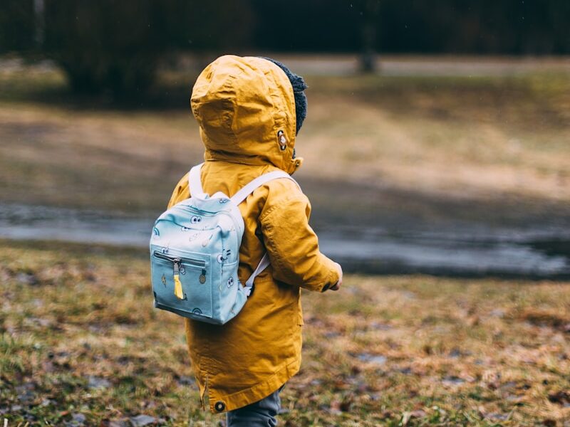 shallow focus photo of toddler walking near river