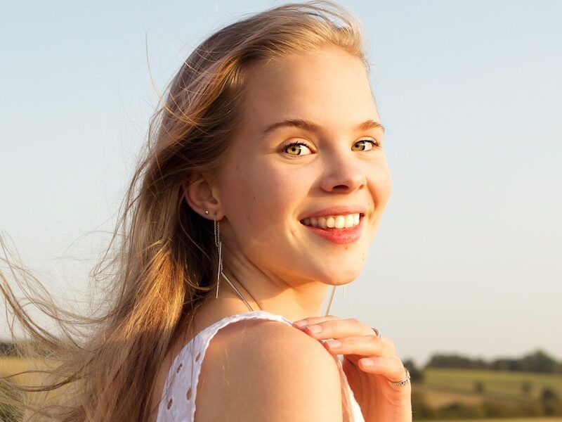 smiling woman in white tank top