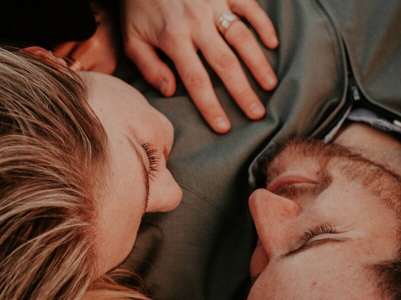 a woman stares into a man's eyes lovingly