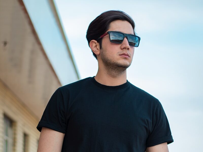 man in black crew neck t-shirt standing during daytime