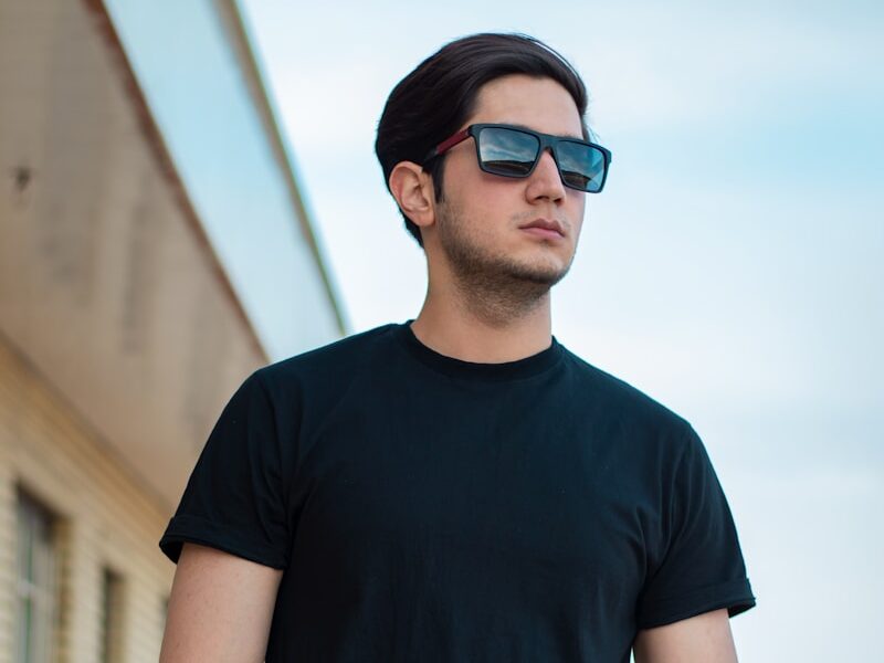 man in black crew neck t-shirt standing during daytime