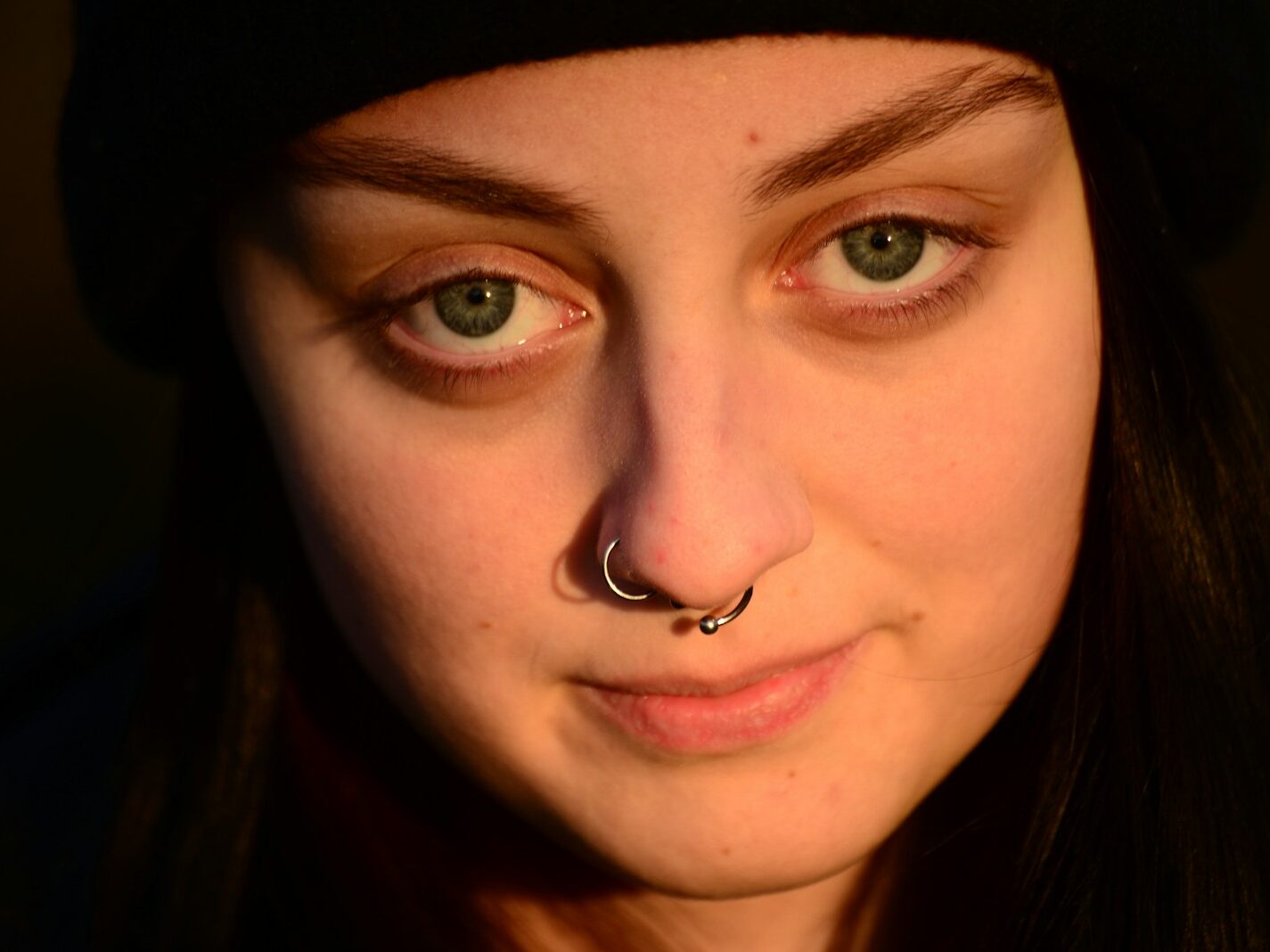 a woman with a nose piercing on her nose