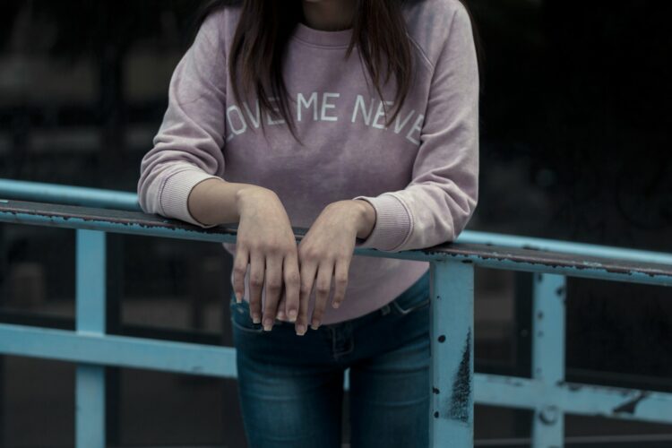 woman in pink hoodie and blue denim jeans