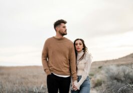 A man and a woman standing in a field