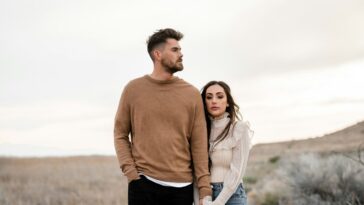 A man and a woman standing in a field