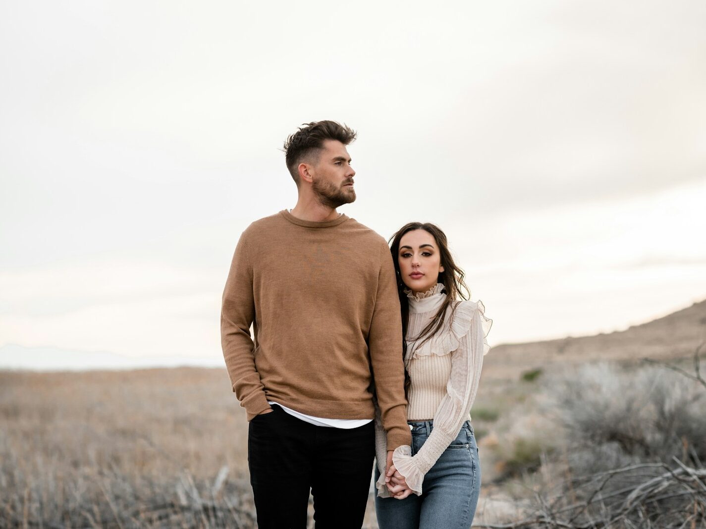 A man and a woman standing in a field