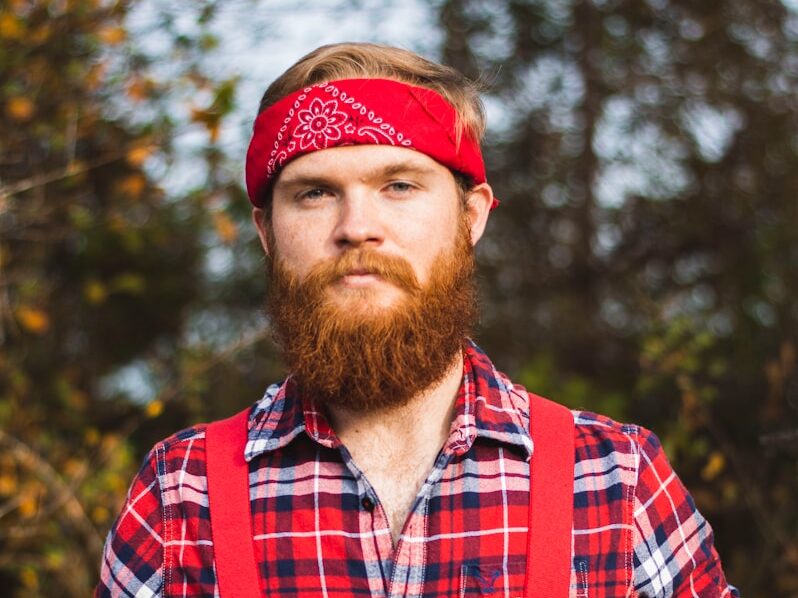 standing man wearing red and white floral kerchief close-up photo