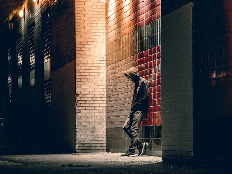 man learning on concrete wall