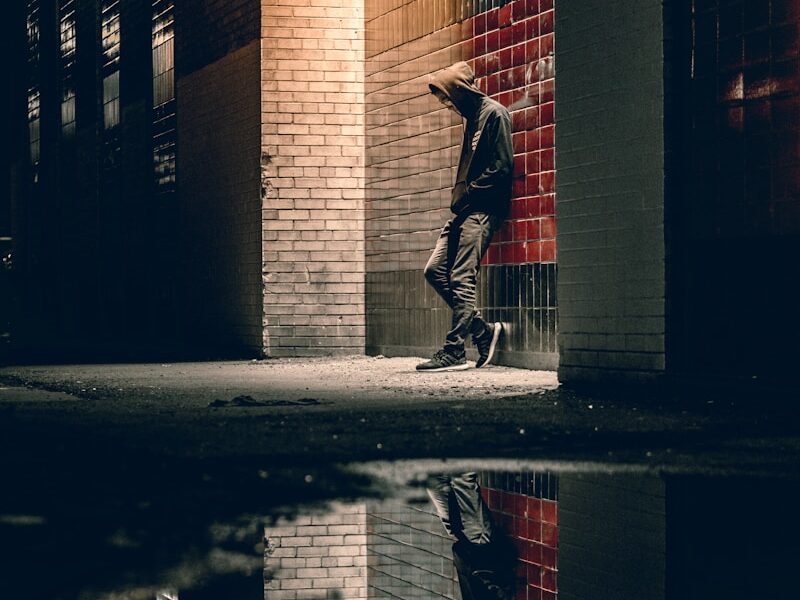 man learning on concrete wall