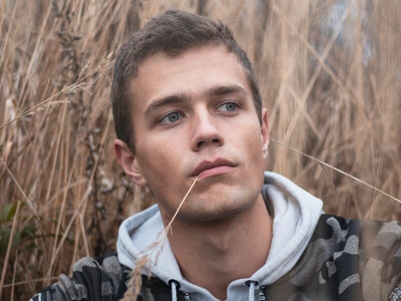 man surrounded by grass