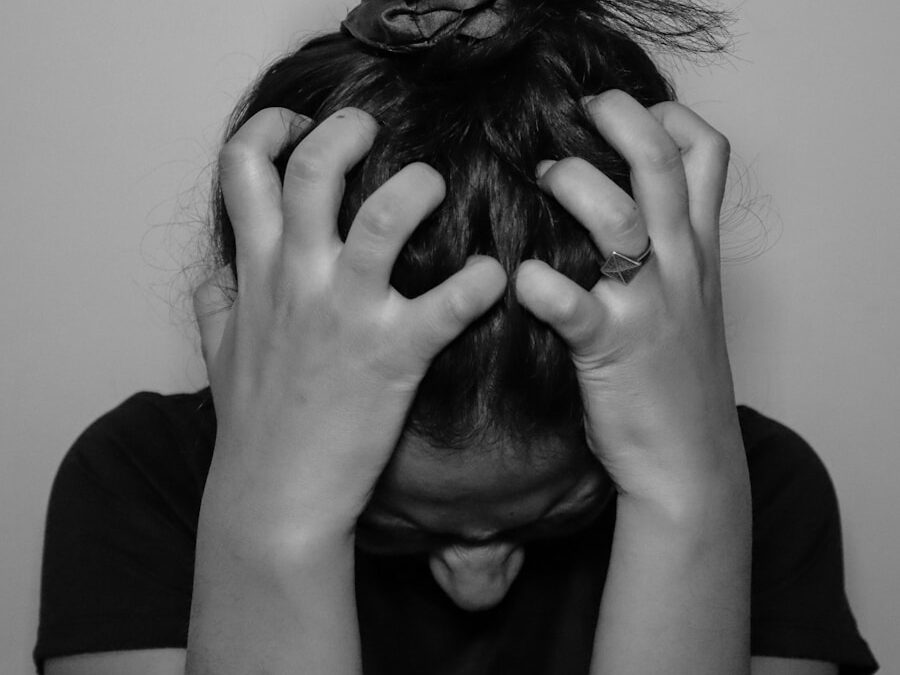 a woman covering her face with her hands