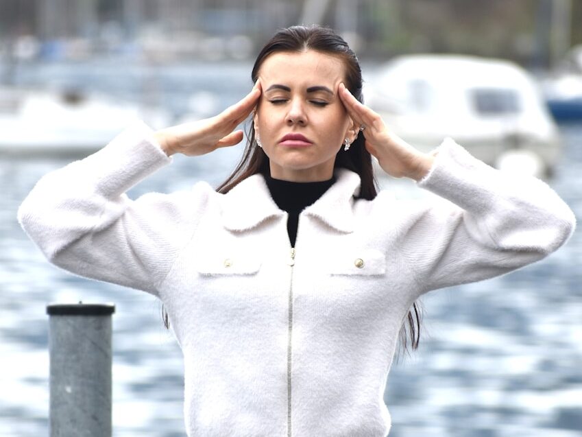 a woman in a white jacket and black skirt