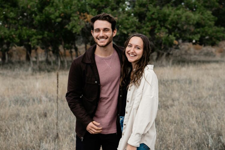 A man and a woman standing in a field