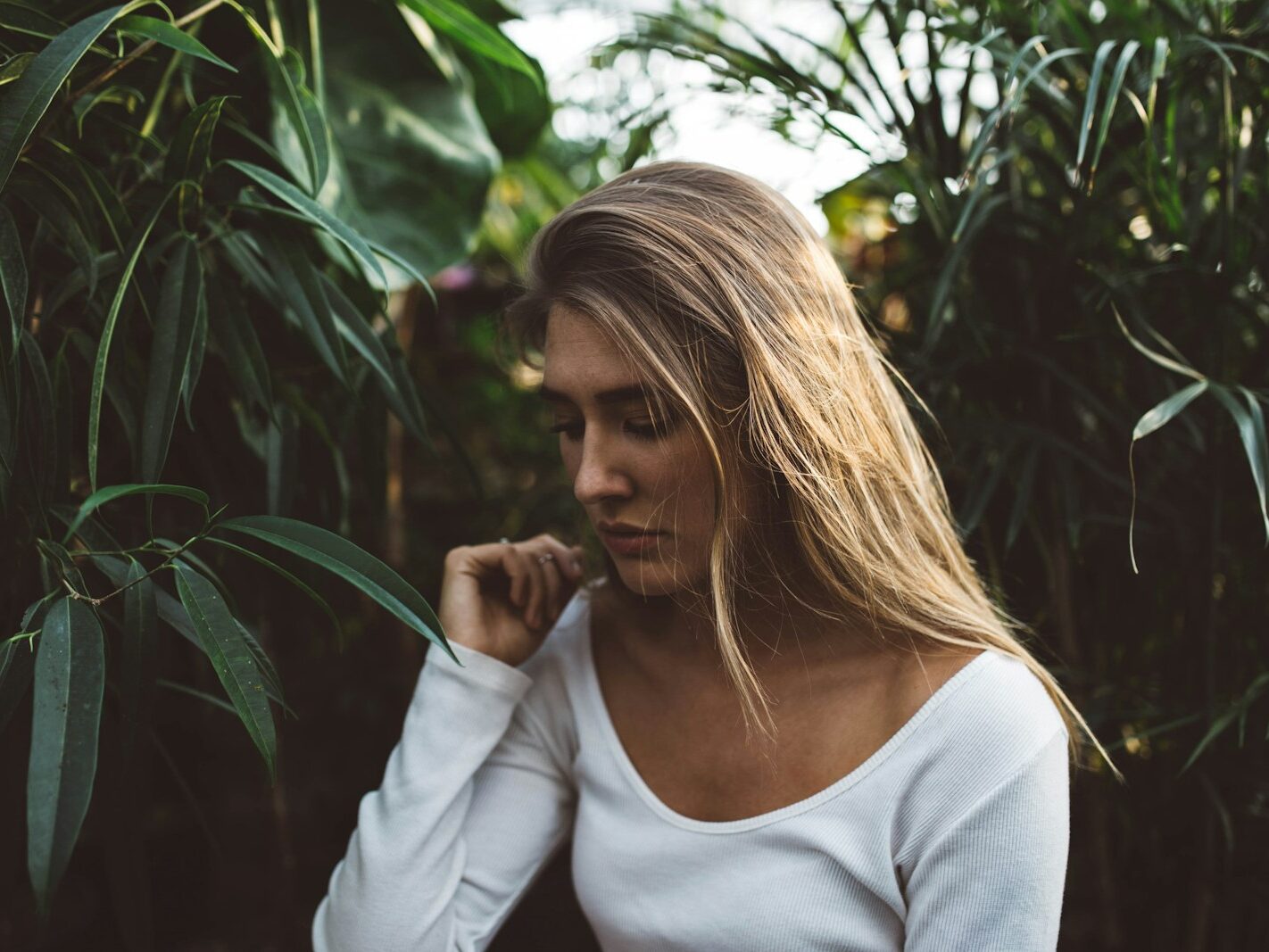 woman near green leafed plants