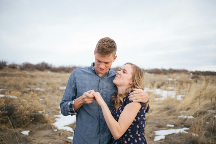 couple standing on the grass field photograph