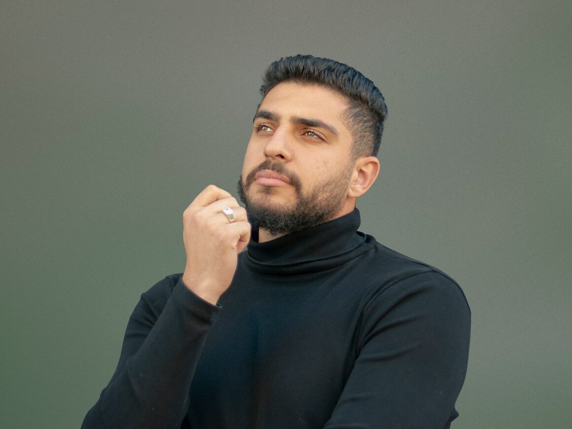 a man wearing a black turtle neck sweater