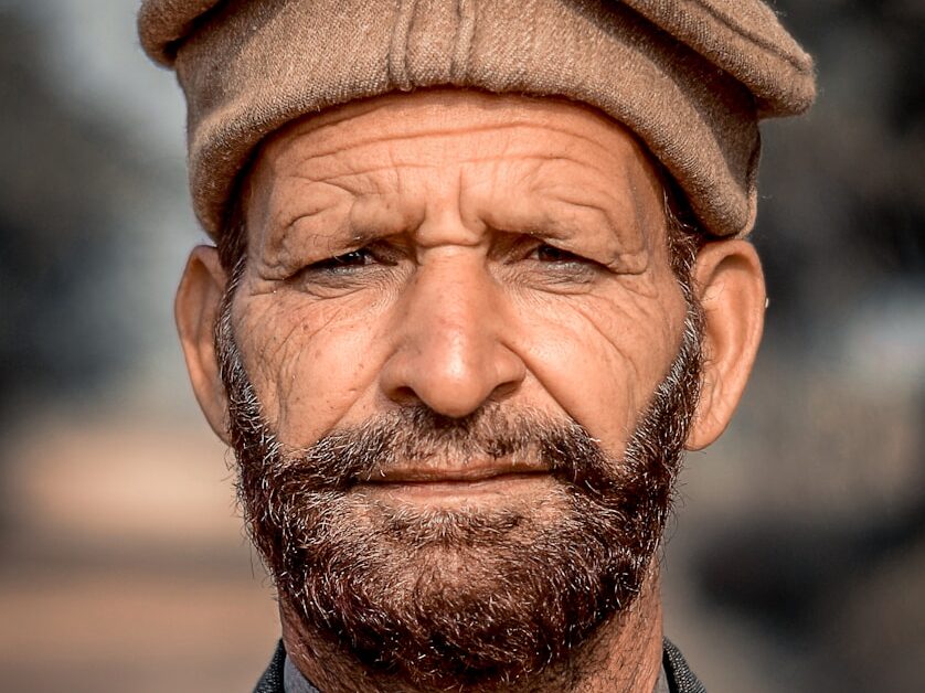 a close up of a man wearing a hat